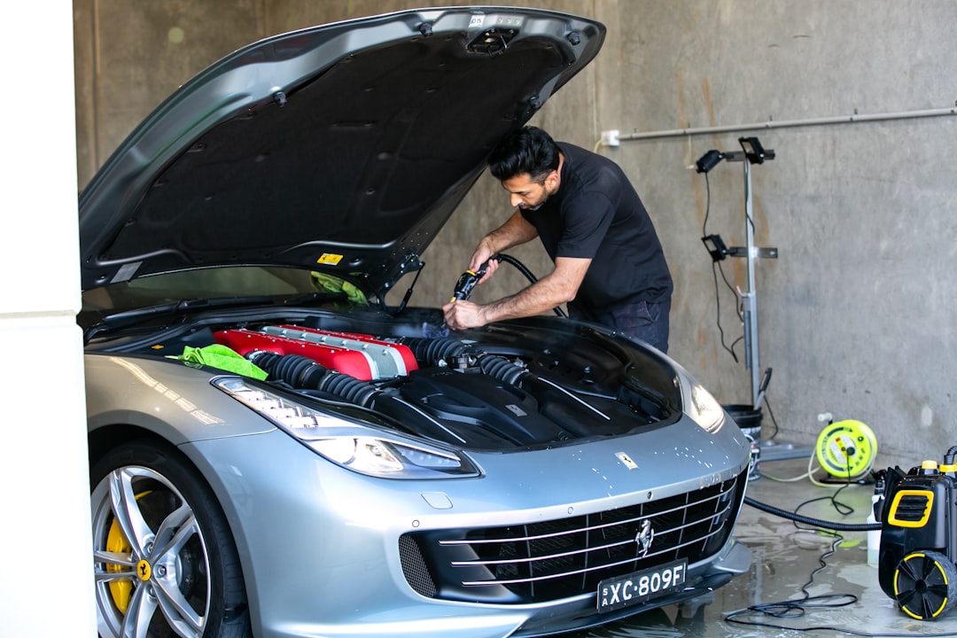 a-mechanic-is-working-on-a-ferrari-car-0w5ec5-niv0